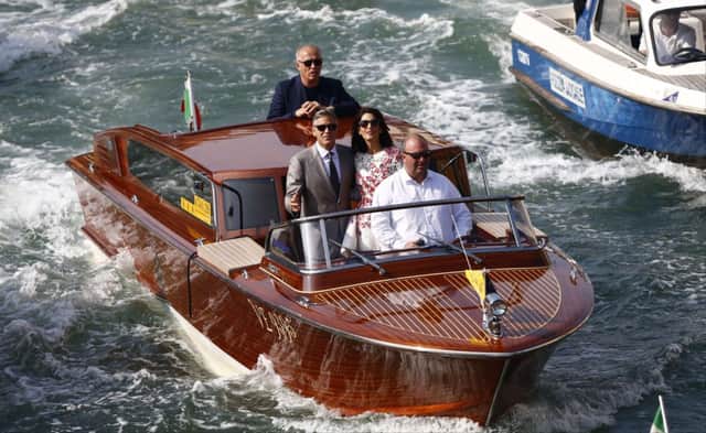 George Clooney and Amal Alamuddin on a Venice taxi boat. Picture: AFP