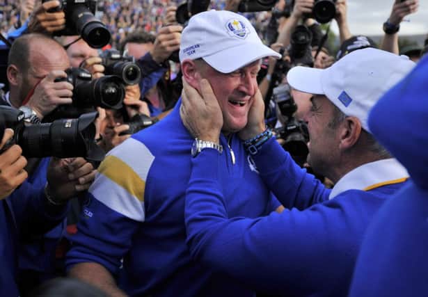 Paul McGinley of Ireland celebrates with Jamie Donaldson on the 15th green. Picture: Getty
