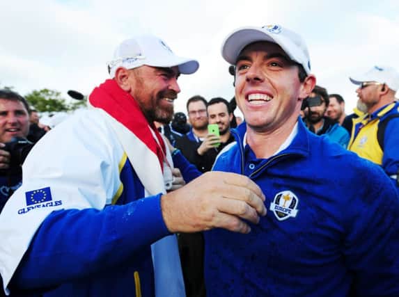 Rory McIlroy celebrates with Thomas Bjorn as Europe savour victory. Picture: Ian Rutherford