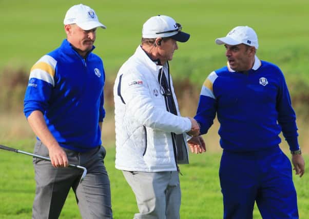 Captains Tom Watson and Paul McGinley shake hands with Jamie Donaldson of Europe looking on. Picture: Getty