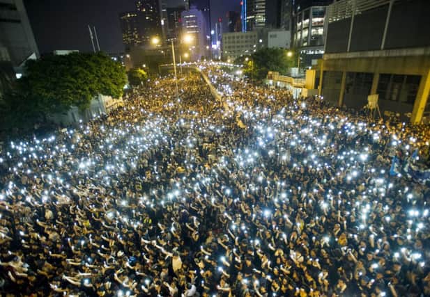 Tens of thousands of pro-democracy demonstrators hold up their mobile phones in a display of solidarity. Picture: Getty