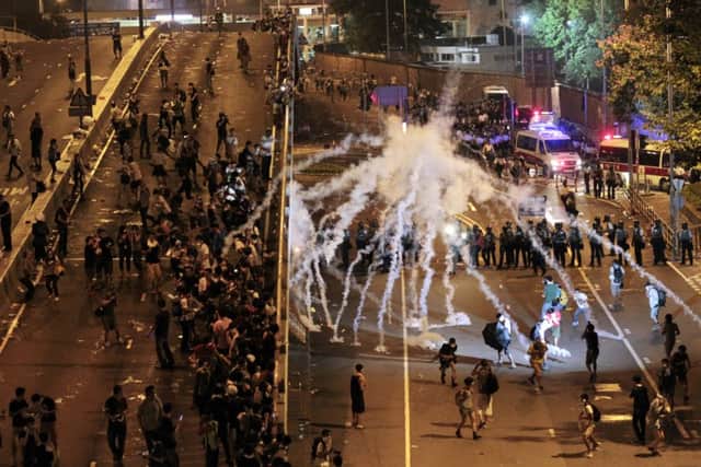 Amid ugly scenes on the streets of Hong Kong investors took a cautious line on HSBC and Standard Chartered. Picture: AP