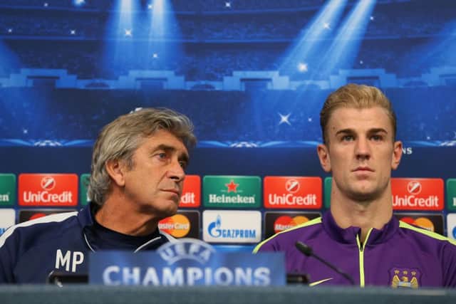 Manchester City manager Manuel Pellegrini and goalkeeper Joe Hart discuss tonights Champions League clash with Roma. Picture: Getty