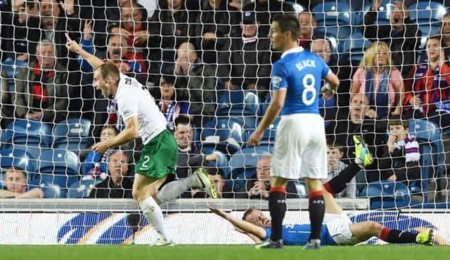 David Gray races off to celebrate after scoring Hibs second goal of a remarkable first half. Picture: SNS
