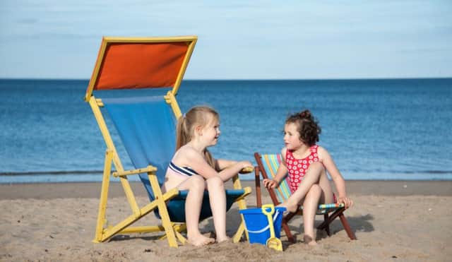 Two six-year-old girls play in the sun on Edinburghs Portobello beach yesterday. Picture: Andy OBrien