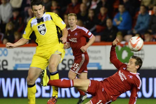 Aberdeen's Peter Pawlett (left) is booked after a bad challenge on St Mirren's John McGinn. Picture: SNS