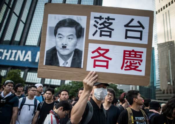 A pro-democracy demonstrator holds a placard depicting Hong Kong chief executive Leung Chun-ying as Hitler. Picture: Getty