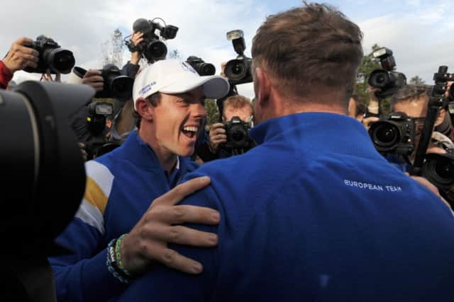 Rory McIlroy celebrates with Jamie Donaldson on the 15th. Picture: Jane Barlow