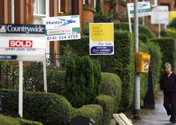 Estate agent billboards are displayed in the West End of Glasgow. Picture: PA