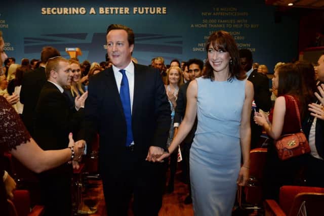 Cameron and wife Samantha are congratulated after his keynote speech at the Tory conference yesterday. Picture: PA