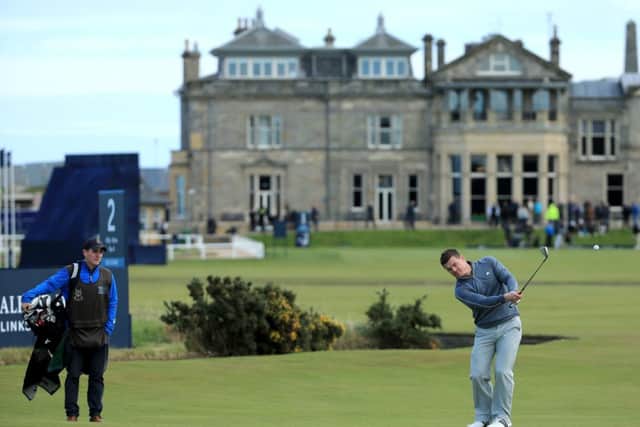 Former Ireland rugby captain Brian ODriscoll plays his shot towards the first green at St Andrews yesterday. Picture: Getty