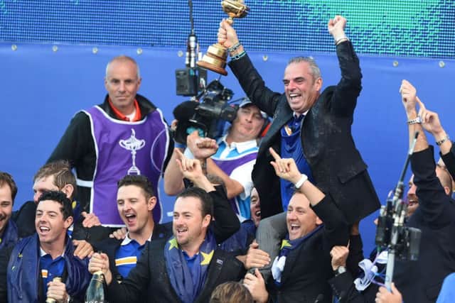 European captain Paul McGinley his held aloft by his players on the stage after the trophy presentation. Picture: Ian Rutherford