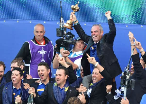 European captain Paul McGinley his held aloft by his players on the stage after the trophy presentation. Picture: Ian Rutherford