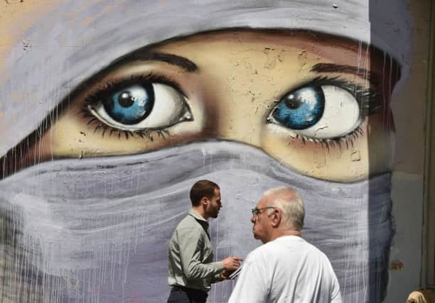 A mural of a Muslim woman on a wall in Sydney, Australia. Picture: Getty