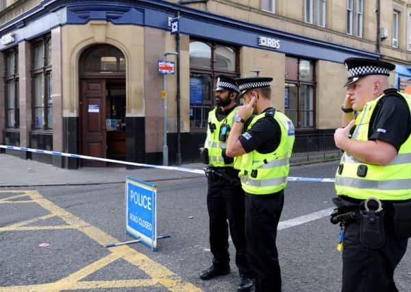 Police attend the scene at Tollcross after a robbery took place in a branch of RBS. Picture: Jane Barlow
