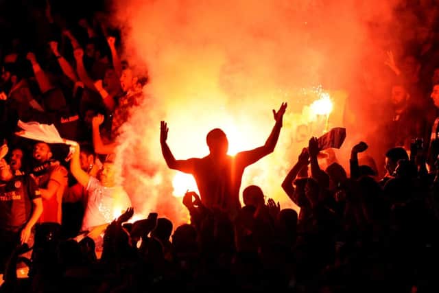 Galatasaray fans let off flares during the match with Arsenal. Now both sides could face punishment. Picture: PA