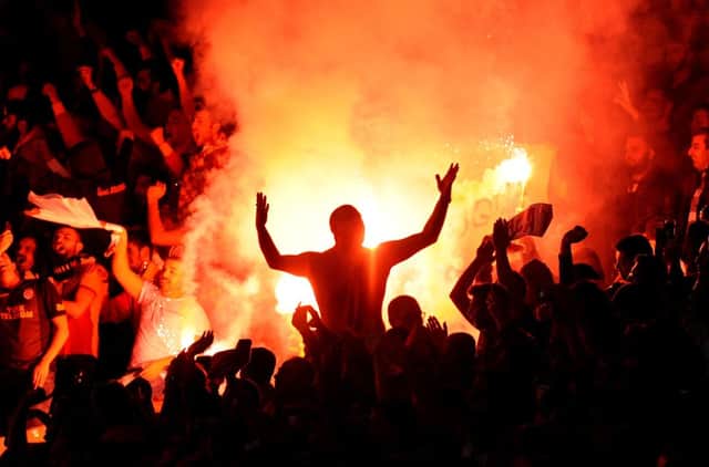Galatasaray fans let off flares during the match with Arsenal. Now both sides could face punishment. Picture: PA
