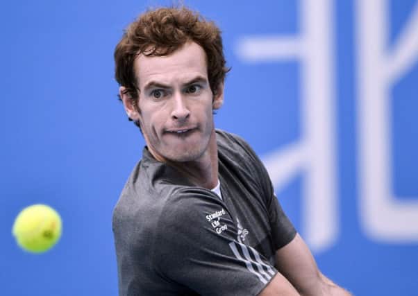 Andy Murray returns a shot during his victory over Marin Cilic. Picture: Getty