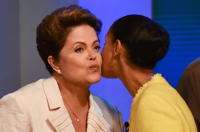Dilma Rousseff, left, is greeted by rival Marina Silva before their TV debate. Picture: Getty