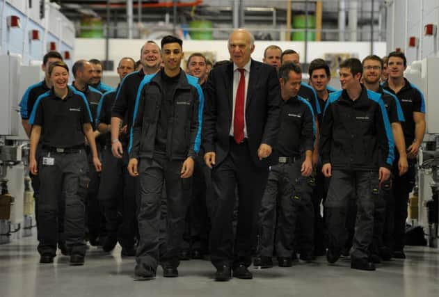 Vince Cable and apprentices at the Scottish Gas training academy in Hamilton yesterday. Picture: Hemedia