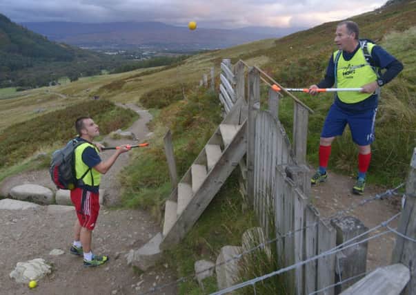 Jon Bleby (left) and Andy Halliday tackle three peaks while hitting, flicking and bouncing a ball. Picture: PA