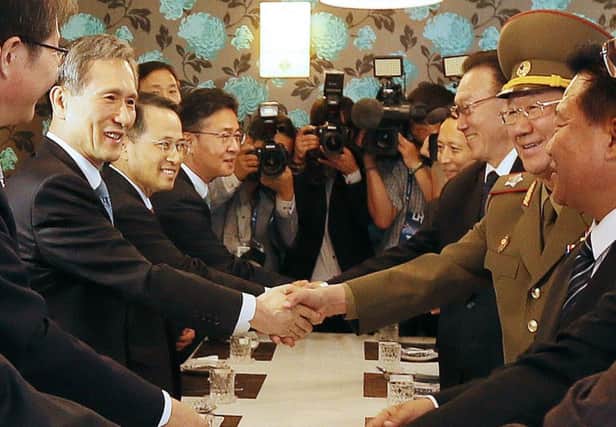 South Korea's national security advisor Kim Kwan-Jin (L) shakes hands with Hwang Pyong-So (2nd R), director of the military's General Political Bureau, the top military post in North Korea, during a luncheon meeting in Incheon, west of Seoul, on October 4, 2014. Three top North Korean officials, including the nuclear-armed nation's de facto number two, made an extremely rare visit to South Korea and held the highest-level talks for years, fuelling hopes of a breakthrough in troubled cross-border ties.  REPUBLIC OF KOREA OUT    AFP PHOTO/KOREA POOLKOREA POOL/AFP/Getty Images