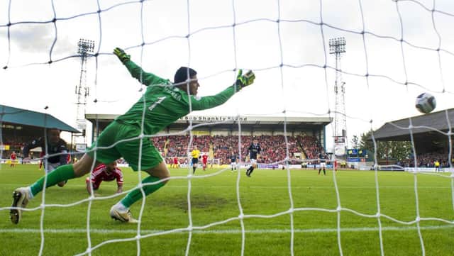 Dundee goalkeeper Kyle Letheren fails to stop the ball hitting the back of the net. Picture: SNS
