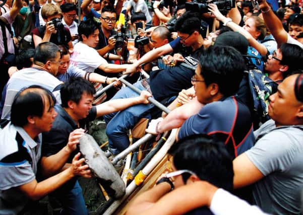 Anti-Occupy Central protesters fight with pro-democracy protesters in Mong Kok district. Photograph: Reuters/Carlos Barria