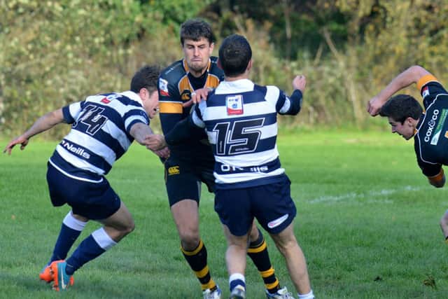 Curries Peter Murchie tries to evade Heriots James Fleming, left, and Charlie Simpson. Picture: Jon Savage
