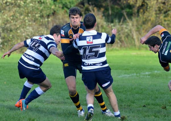 Curries Peter Murchie tries to evade Heriots James Fleming, left, and Charlie Simpson. Picture: Jon Savage