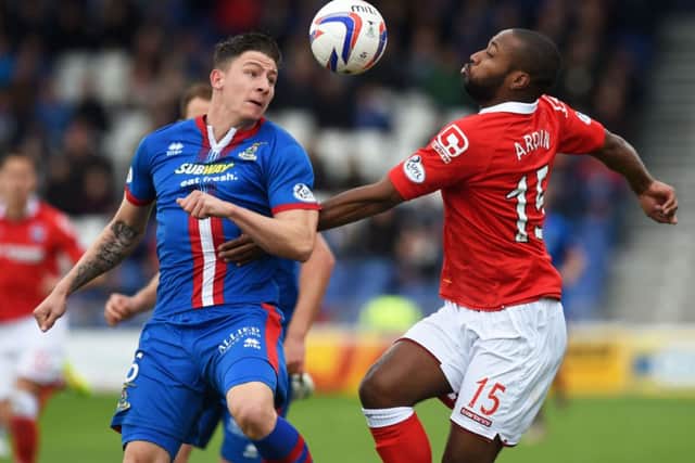 Goalscorer Yoann Arquin, right, battles for a high ball with Josh Meekings. Picture: SNS