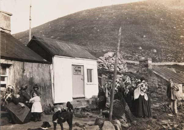 Women and children with their dogs gathered around the St Kilda post office. Picture: University of Glasgow