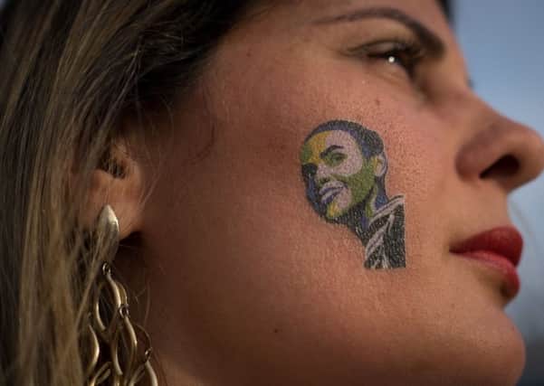One of Brazils 145 million voters uses a face painting to show her support for presidential candidate Marina Silva, of the Brazilian Socialist Party. Picture: Getty