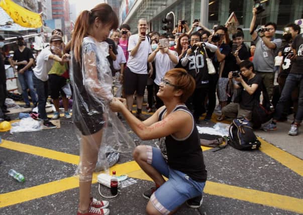 A lighter moment in the occupation as a student proposes to his girlfriend; below, messages of support have flooded in. Picture: Reuters