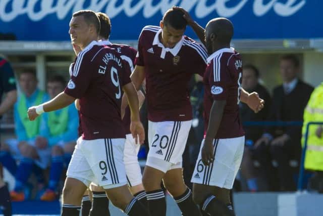 Osman Sow (No 20) celebrates with his team-mates after giving Hearts the lead against Queen of the South. Picture: SNS