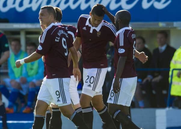 Osman Sow (No 20) celebrates with his team-mates after giving Hearts the lead against Queen of the South. Picture: SNS