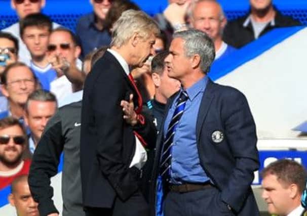 Arsene Wenger and Jose Mourinho exchange views on the touchline. Picture: PA
