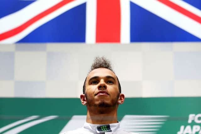 A subdued Lewis Hamilton on the podium following his victory in the shortened Japanese GP. Picture: Getty