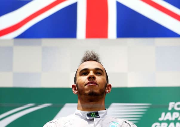 A subdued Lewis Hamilton on the podium following his victory in the shortened Japanese GP.  Picture: Getty