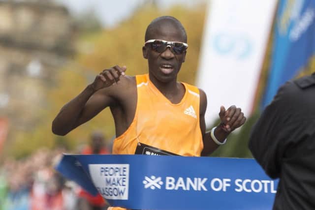 Stephen Mokoka breaks the tape at the finishing line to win the Great Scottish Run in Glasgow yesterday. Picture: PA