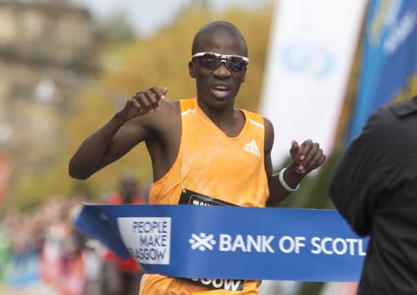 Stephen Mokoka breaks the tape at the finishing line to win the Great Scottish Run in Glasgow yesterday. Picture: PA