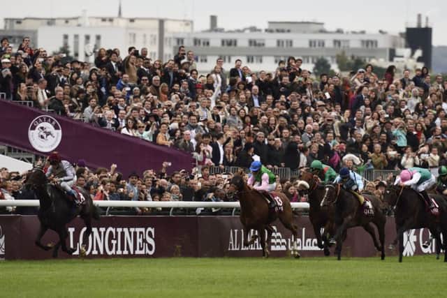 Treve, left, ridden by Thierry Jarnet leads the Qatar Arc de Triomphe  at Longchamp. Picture: Getty