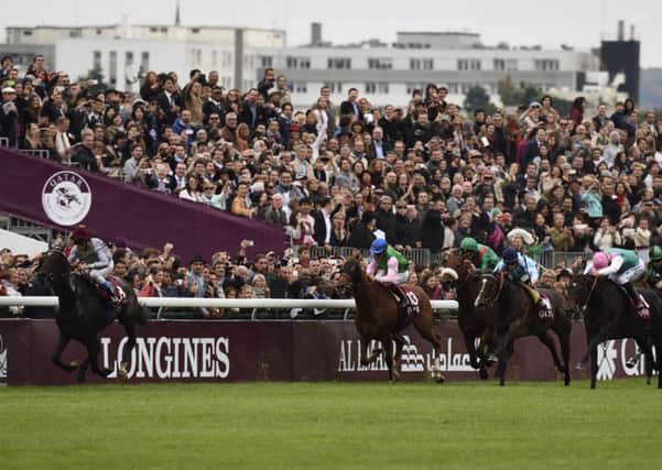 Treve, left, ridden by Thierry Jarnet leads the Qatar Arc de Triomphe  at Longchamp. Picture: Getty