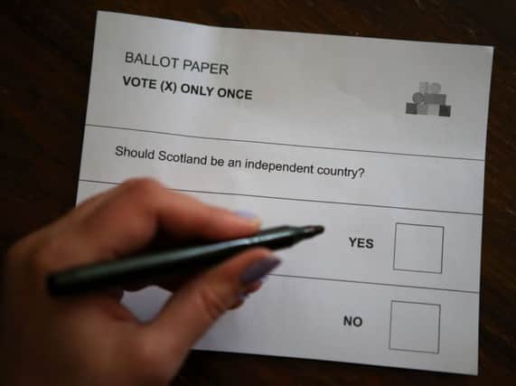 A person holds a pen ready to mark their ballot paper ahead of voting in the Scottish referendum. Picture: PA