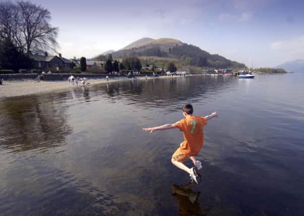 A young swimmer dives into the water at Loch Lomond. Significant restrictions will be put in place in Loch Lomond and the Trossachs to protect the sites. Picture: Donald Macleod