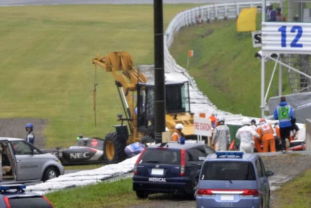 Rescuers gather around the car of Jules Bianchi after crash during Japanese Grand Prix. Picture: AP