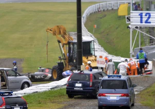 Rescuers gather around the car of Jules Bianchi after crash during Japanese Grand Prix. Picture: AP