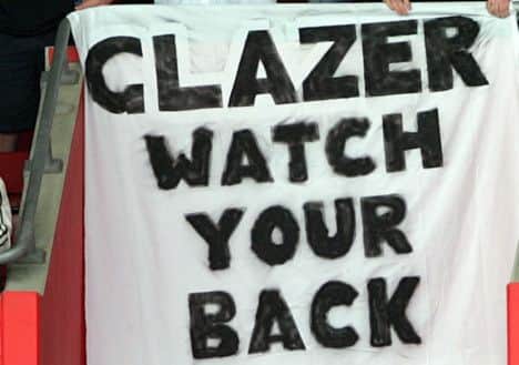 Manchester United fans show their displeasure at American Malcolm Glazer's takeover of the club, during their English Premiership soccer match against Southampton played at St Mary's Stadium, Southampton, England. Sunday May 15 2005. (AP Photo/Paul Ellis) **NO INTERNET/MOBILE USEAGE WITHOUT FAPL LICENCE - SEE IPTC SPECIAL INSTRUCTIONS FIELD FOR DETAILS**