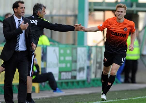 Stuart Armstrong, pictured celebrating with Dundee United coach Darren Jackson after scoring, is a target for Hull. Picture: Ian Rutherford
