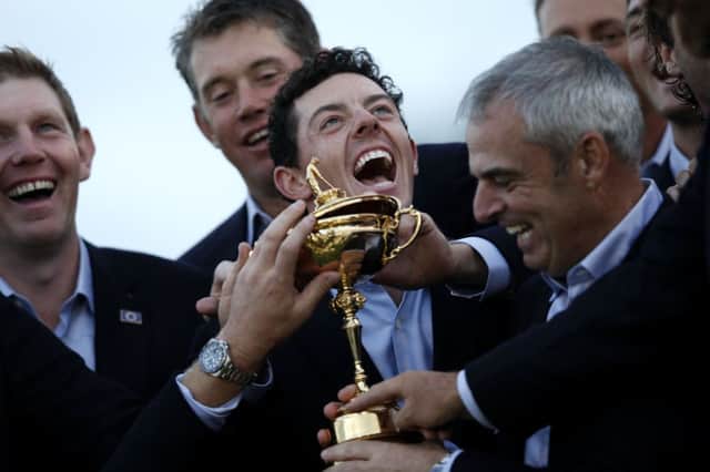Rory McIlroy, centre, celebrates Ryder Cup success for Europe with captain Paul McGinley, right. Picture: Getty